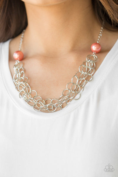 Two oversized coral pearls give way to dramatic silver chains, creating bold layers below the collar for a sassy look. Features an adjustable clasp closure.  Sold as one individual necklace. Includes one pair of matching earrings.