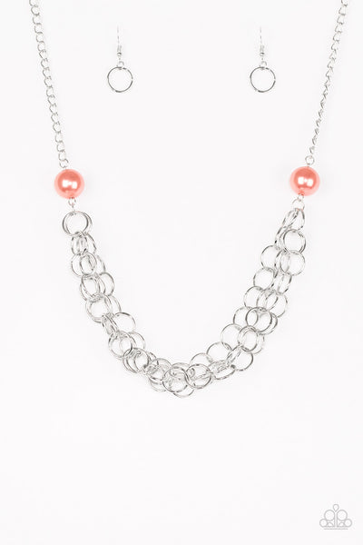 Two oversized coral pearls give way to dramatic silver chains, creating bold layers below the collar for a sassy look. Features an adjustable clasp closure.  Sold as one individual necklace. Includes one pair of matching earrings.